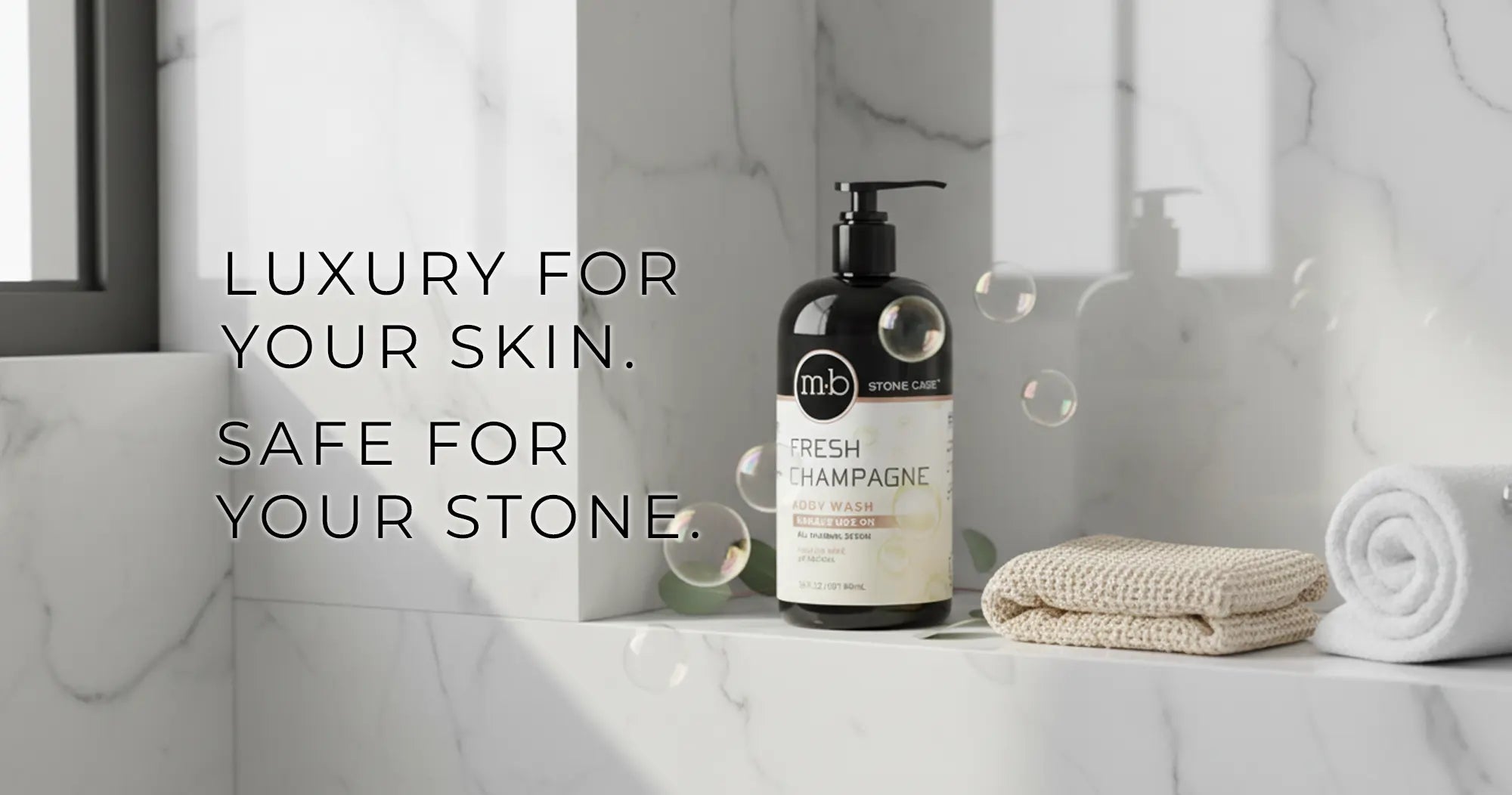 Bottle of 'mb' Fresh Champagne soap on a marble surface with text 'Luxury for your skin. Safe for your stone'.
