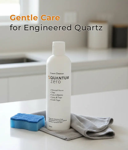 Bottle of Quantum Zero cleaner on a kitchen counter with cleaning tools, text 'Gentle Care for Engineered Quartz'.