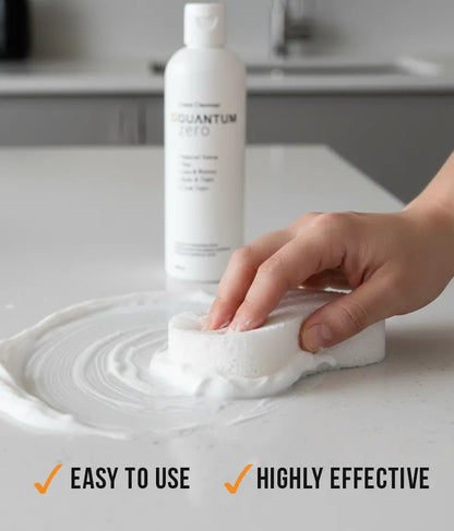 Person using a cleaning product on a surface with a bottle labeled 'Quantum' in the background.