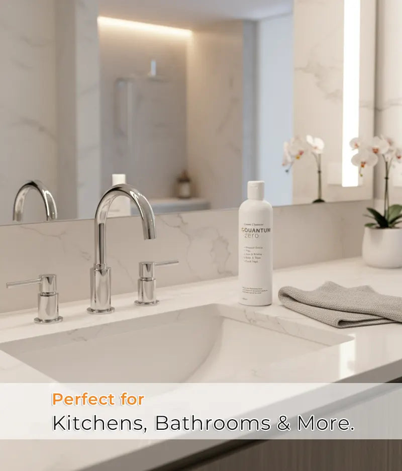 Bathroom counter with sink, faucet, and a bottle of Quantum Ultra on a light background.