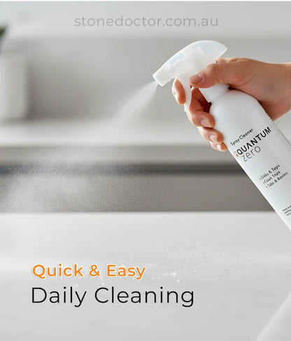 Hand holding a spray bottle labeled 'Quantum Zero' over a sink with text 'Quick & Easy Daily Cleaning'.