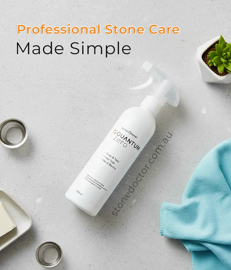 White bottle with 'stonedoctor.com.au' branding on a gray surface with cleaning tools and a plant.