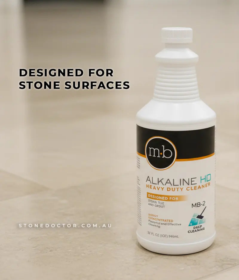 Alkaline HD Heavy Duty Cleaner bottle on a stone surface with text 'Designed for Stone Surfaces'.